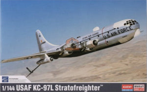 Model of a USAF KC-97L Stratofreighter airplane on a desert background with clear blue sky.
